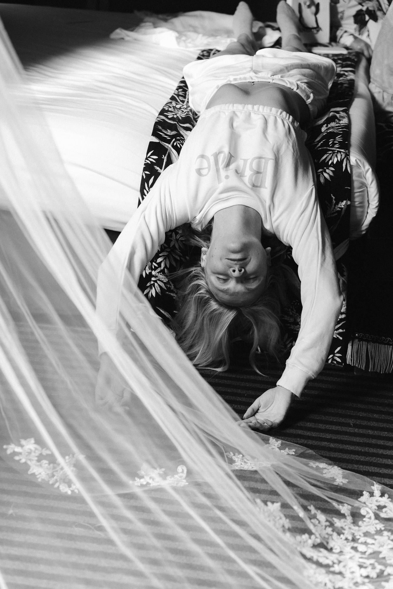 Paris wedding photographer: The bride tries to stretch a little before the start of her wedding at Hotel Particulier de Montmartre