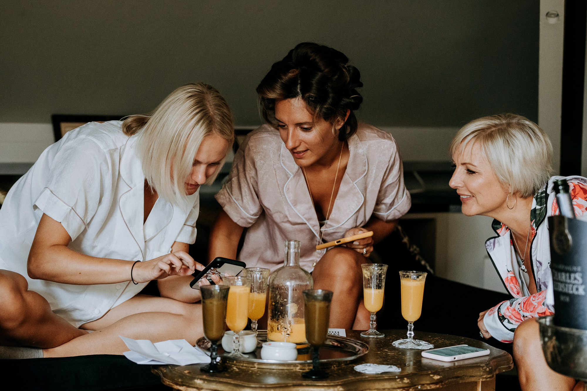 Mimosas are served, the bride enjoys a relaxing moment with her maid of honor and her mum