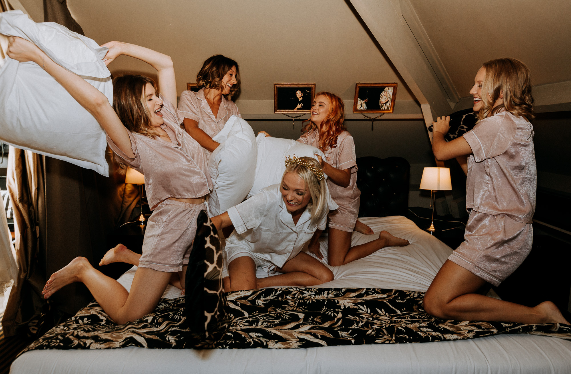 pillow fight between the bride and her bridesmaids