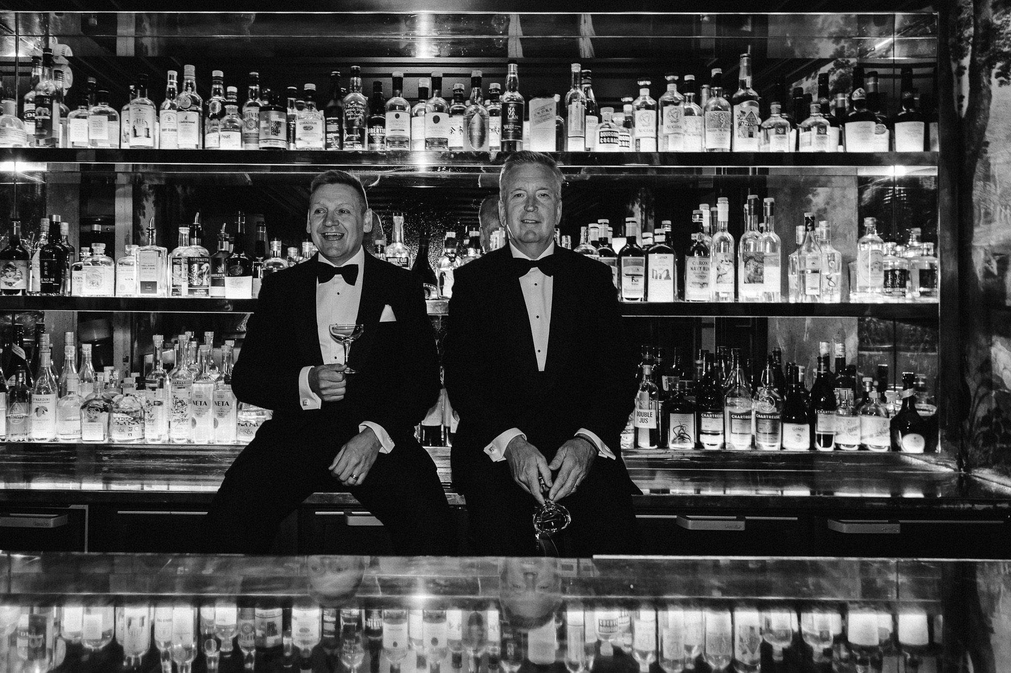 Paris wedding photographer: the two dads are posing in front of the Très Particulier bar in Montmartre before the ceremony