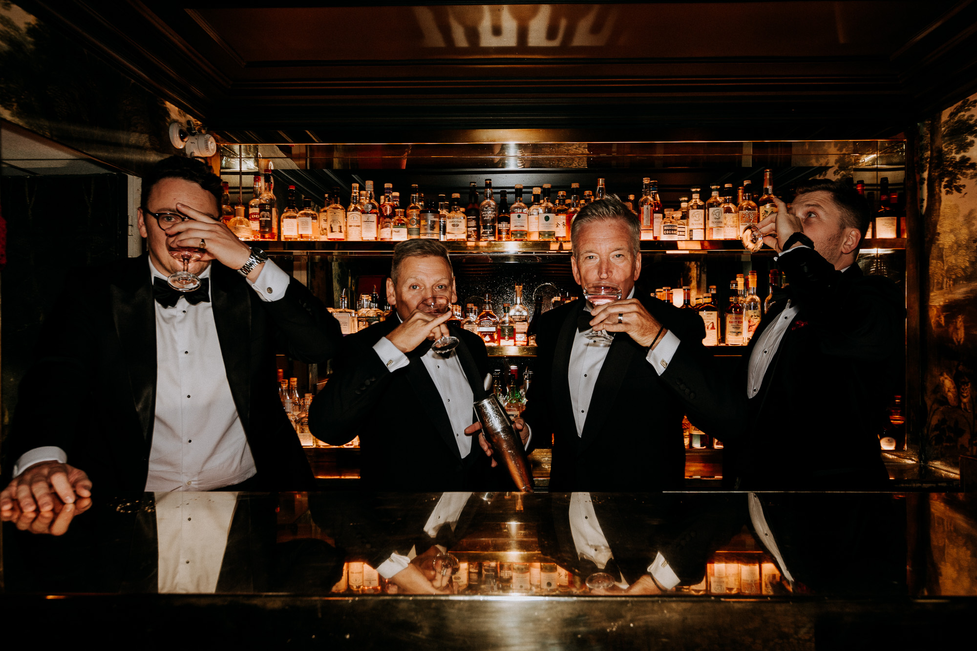 Paris wedding photographer: the two dads, the groom and his best man are posing in front of the Très Particulier bar in Montmartre before the ceremony