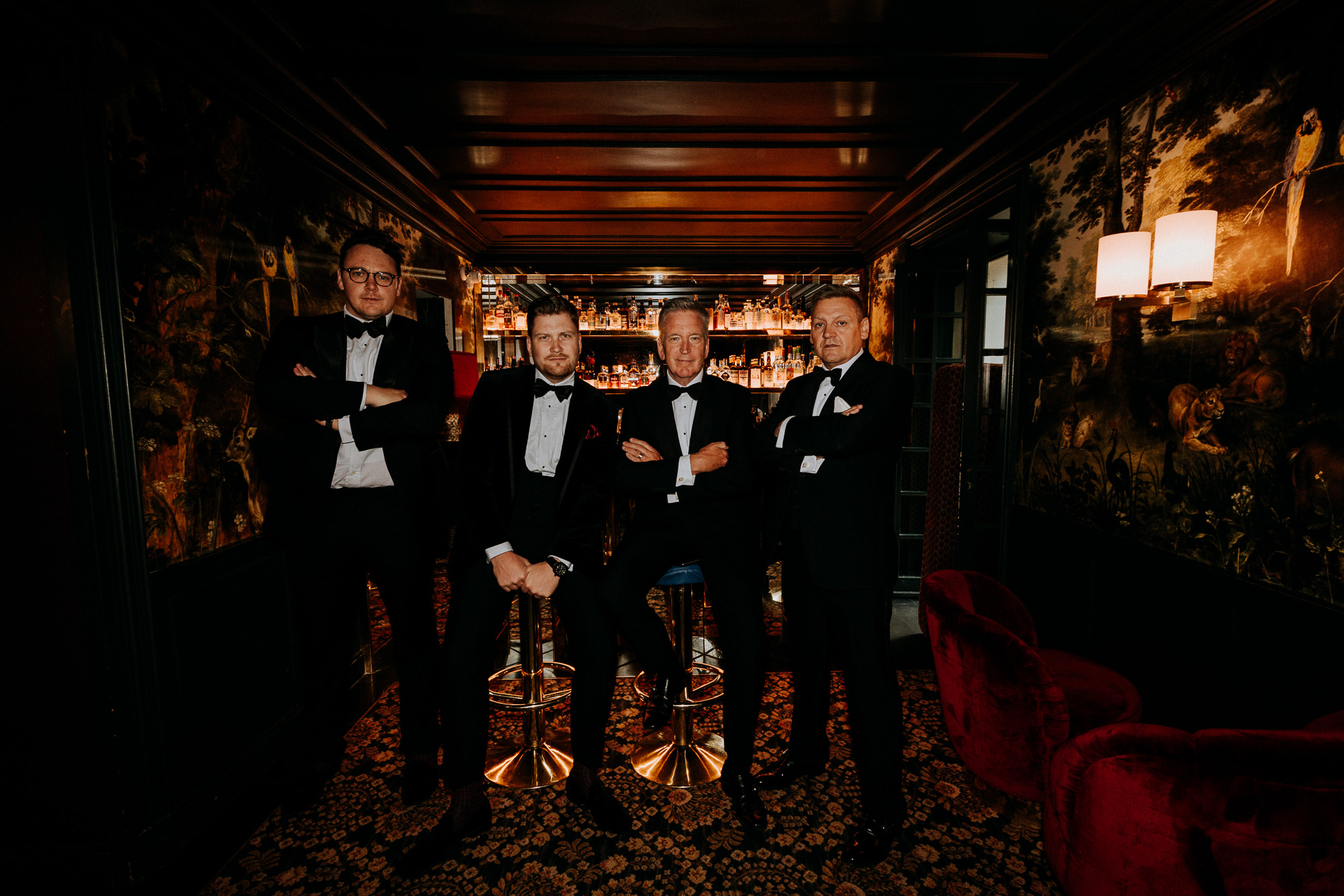 Paris wedding photographer: the two dads, the groom and his best man are posing in front of the Très Particulier bar in Montmartre before the ceremony