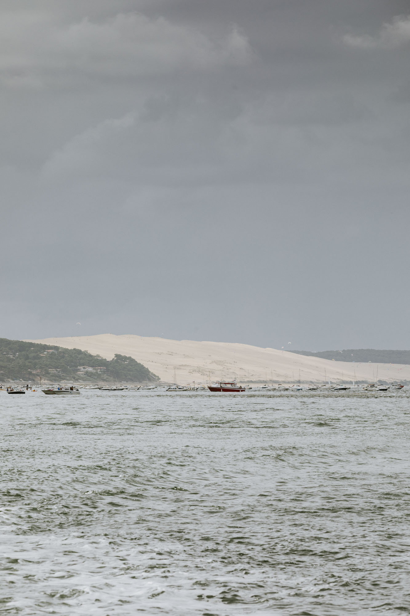 Arcachon wedding photographer: we get treated to a nice view over the Dune of Pyla from the boat crossing the bay