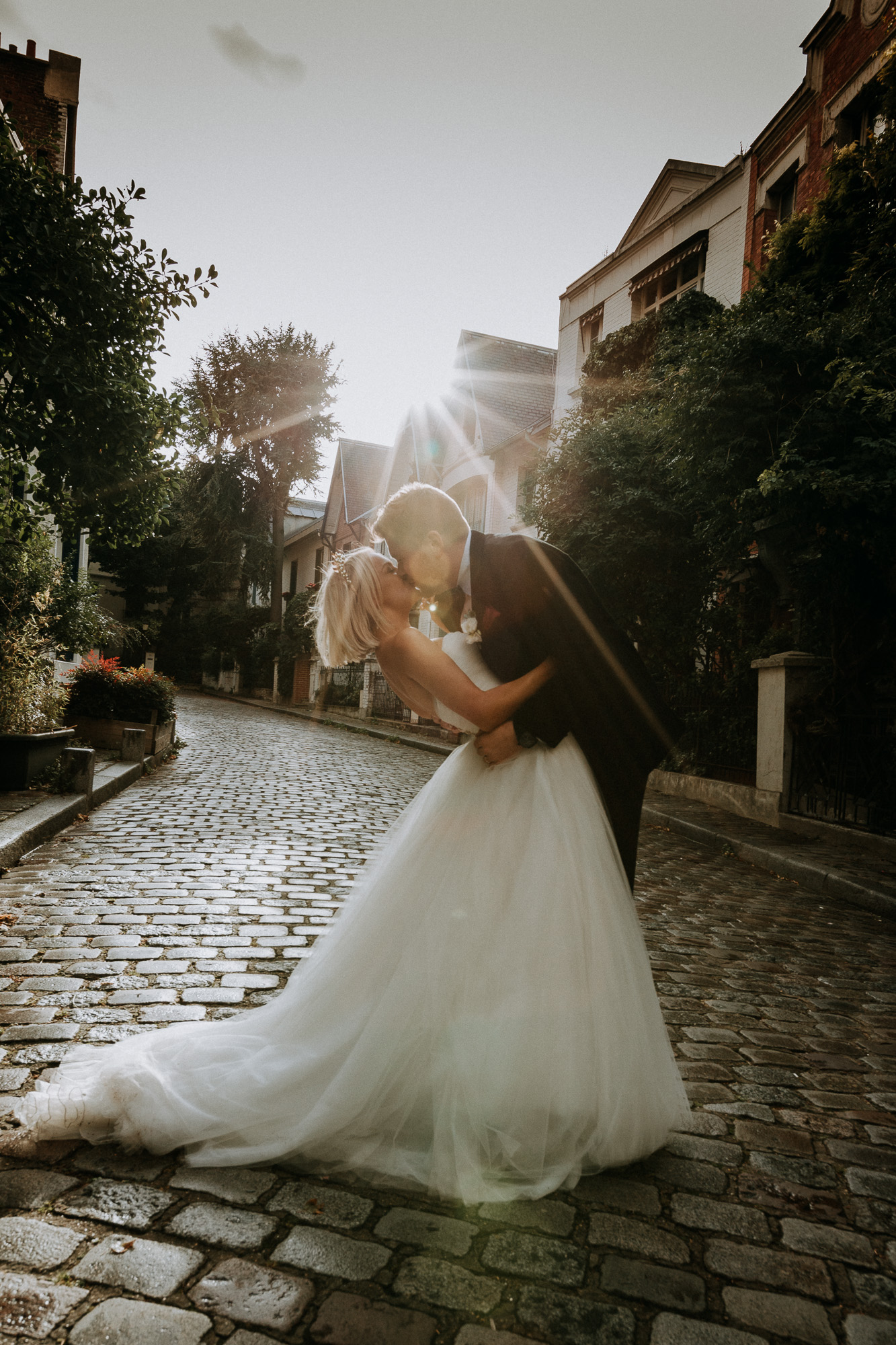 Séance photo des mariés dans les ruelles et les marches de Montmartre à Paris, ici à l'entrée de la villa Léandre